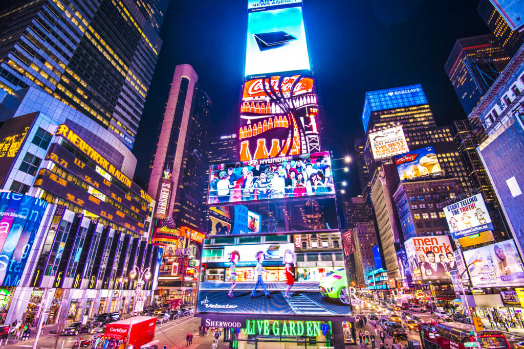 Times Square illuminated at night with bright advertising screens during the Night Lights of Manhattan private limousine tour