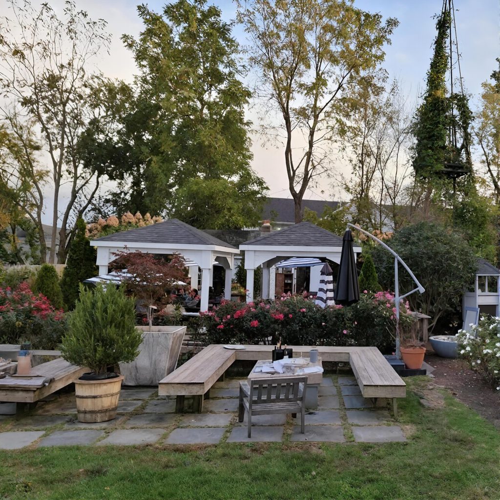 Outdoor yard at Mattebella Vineyards with benches, tables, and gazebos on the North Fork of Long Island during a Long Island wine tour.