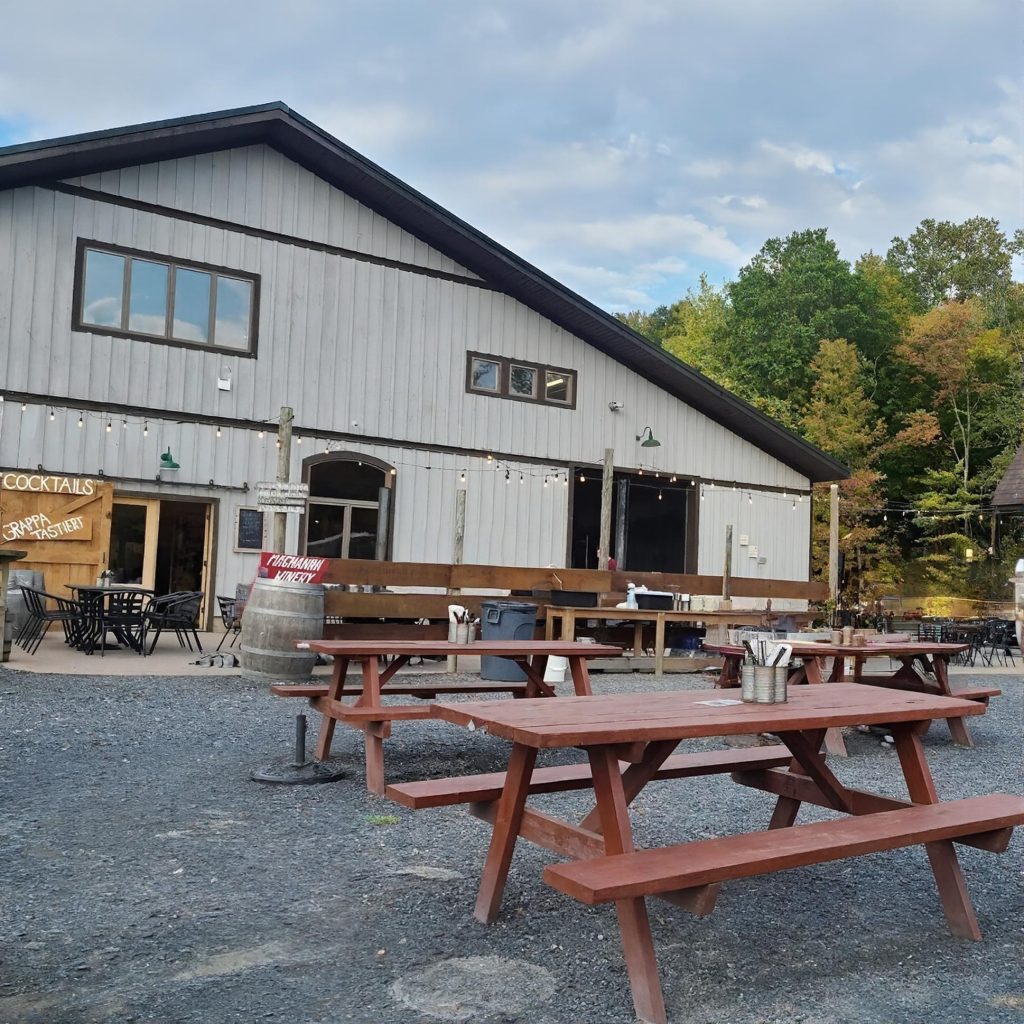Outdoor tables at Magnanini Winery in the Hudson Valley during a chauffeured wine tasting tour from New York City.