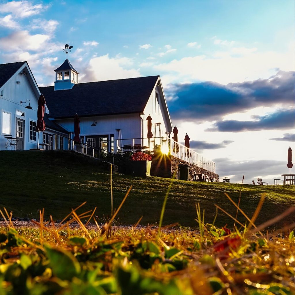 View of the winery house at Milea Estate Vineyard from the outdoor lawn during a chauffeured wine tasting tour from New York City.